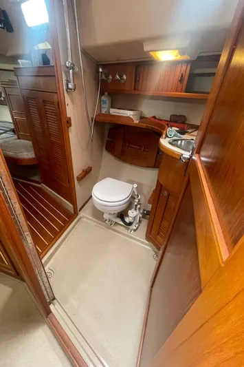  Yacht Photos Pics 1995 Island Packet 40 yacht bathroom with wooden cabinetry, toilet, and sink.
