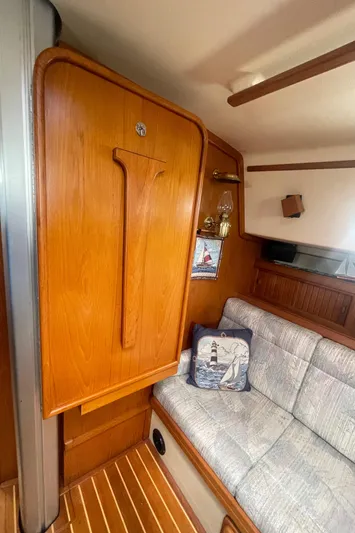  Yacht Photos Pics Interior of 1995 Island Packet 40 sailboat with wooden cabinetry and cushioned seating.