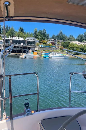  Yacht Photos Pics Sailboat view of marina with shoreline buildings, Island Packet 40, 1995 model.