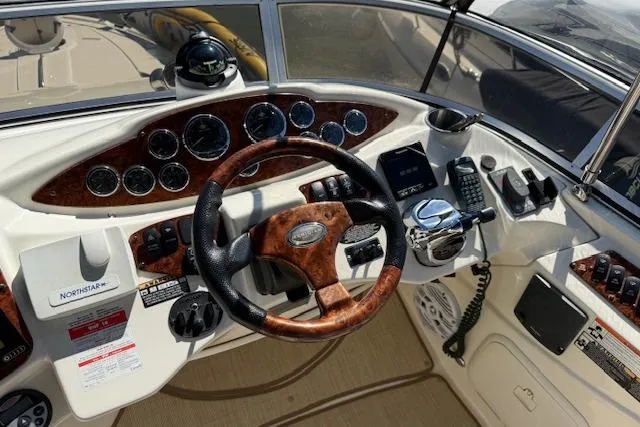  Yacht Photos Pics Cockpit of 2008 Meridian 391 Sedan with wood-accented steering wheel and control panel.