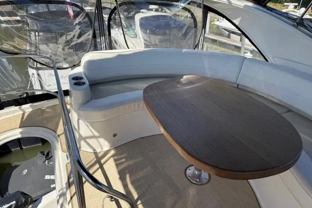  Yacht Photos Pics 2008 Meridian 391 Sedan yacht interior with curved seating and wooden table.