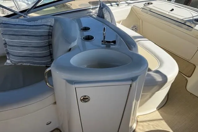  Yacht Photos Pics 2008 Meridian 391 Sedan yacht interior with sink, seating, and striped cushion.