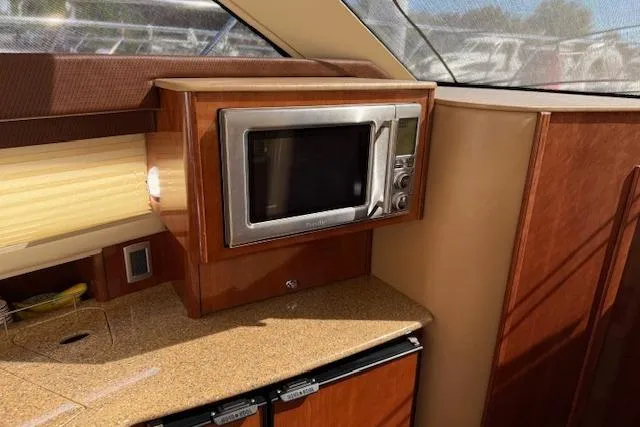  Yacht Photos Pics 2008 Meridian 391 Sedan interior with microwave and wooden cabinetry.