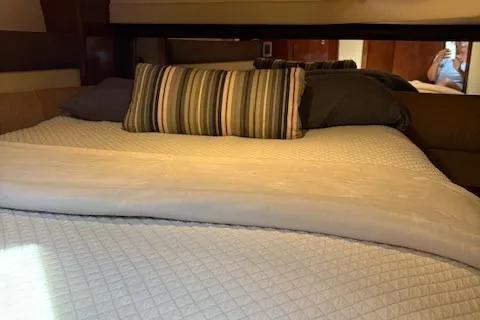 Yacht Photos Pics Interior cabin of 2008 Meridian 391 Sedan with cozy bedding and striped pillow.