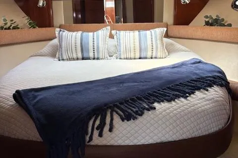  Yacht Photos Pics Luxurious interior of 2008 Meridian 391 Sedan with cozy bedding and stylish decor.