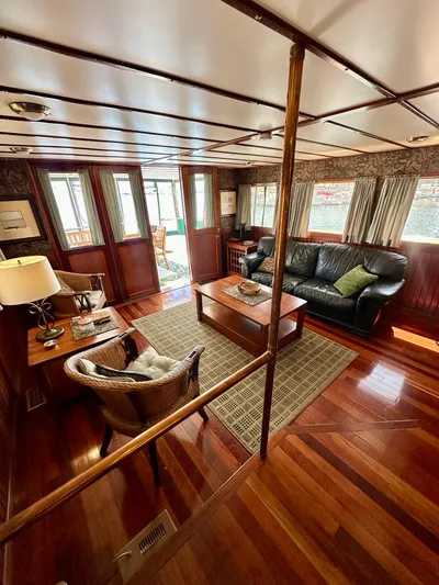 Boatel I Yacht Photos Pics Luxurious interior of a 1998 Custom 65 Foot Trawler with elegant wood finishes and cozy seating.