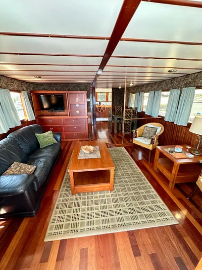 Boatel I Yacht Photos Pics Luxurious interior of a 1998 Custom 65 Foot Trawler with elegant wood flooring.