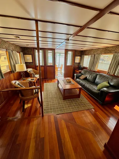 Boatel I Yacht Photos Pics Luxurious interior of a 1998 Custom 65 Foot Trawler with elegant wood flooring and cozy seating.