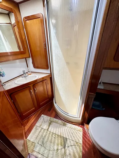 Boatel I Yacht Photos Pics Bathroom in 1998 Custom 65 Foot Trawler with shower, sink, and wooden cabinetry.