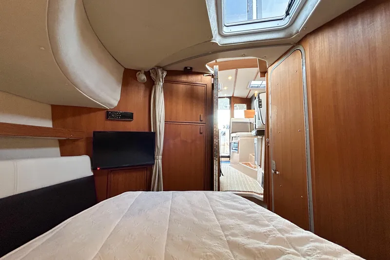  Yacht Photos Pics Interior cabin of 2017 Ranger Tugs R-31 CB with bed, TV, and wooden finish.