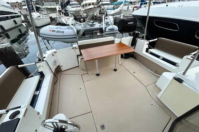  Yacht Photos Pics 2017 Ranger Tugs R-31 CB boat interior with seating and table in marina setting.