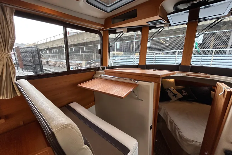  Yacht Photos Pics Interior of 2017 Ranger Tugs R-31 CB with wood accents and seating area.