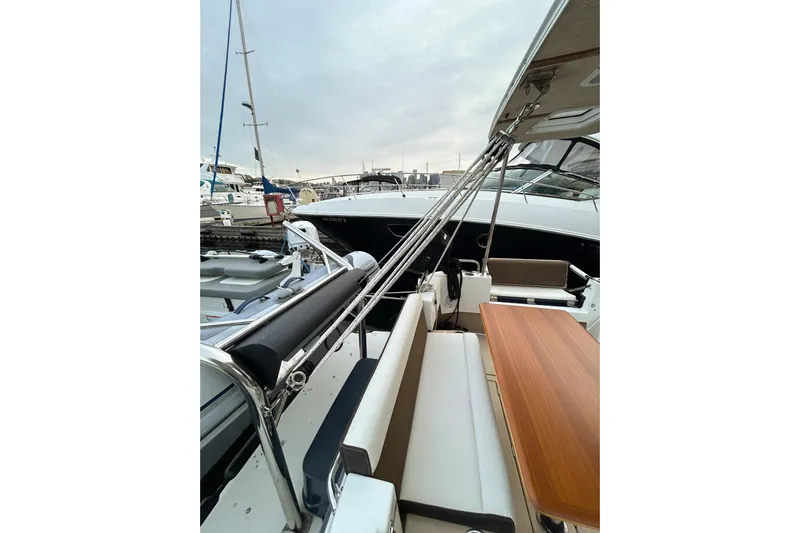  Yacht Photos Pics 2017 Ranger Tugs R-31 CB boat interior with seating and wooden table at marina.