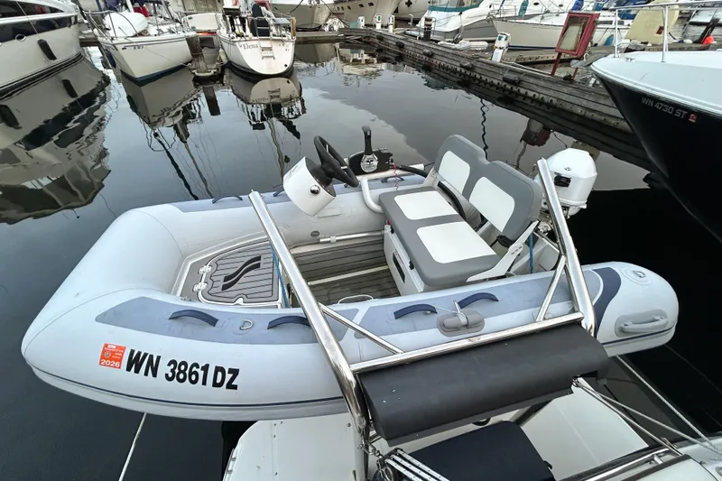  Yacht Photos Pics Inflatable boat docked at marina, near Ranger Tugs R-31 CB, 2017 model.