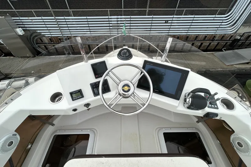  Yacht Photos Pics 2017 Ranger Tugs R-31 CB helm with steering wheel, navigation controls, and display screen.