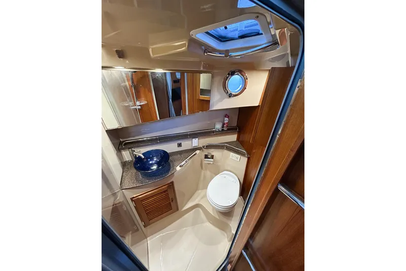  Yacht Photos Pics Luxurious bathroom in 2017 Ranger Tugs R-31 CB with modern fixtures and porthole window.
