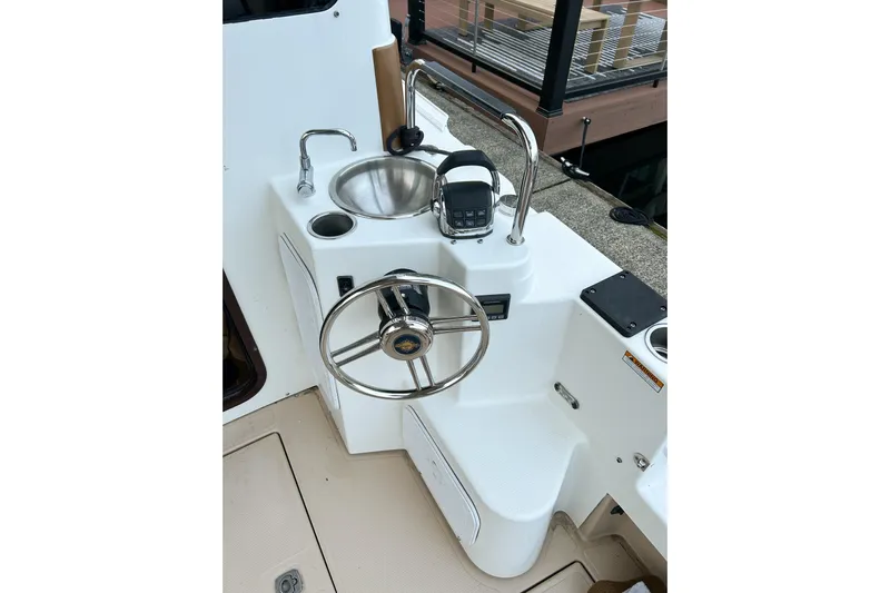  Yacht Photos Pics 2017 Ranger Tugs R-31 CB helm with steering wheel, sink, and controls.