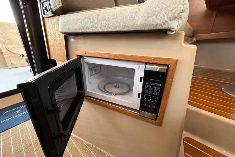  Yacht Photos Pics 2017 Ranger Tugs R-31 CB interior microwave with open door, showcasing modern amenities.