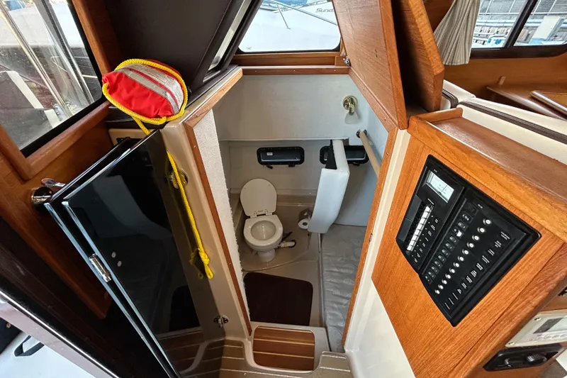  Yacht Photos Pics 2017 Ranger Tugs R-31 CB boat interior with compact bathroom and control panel.