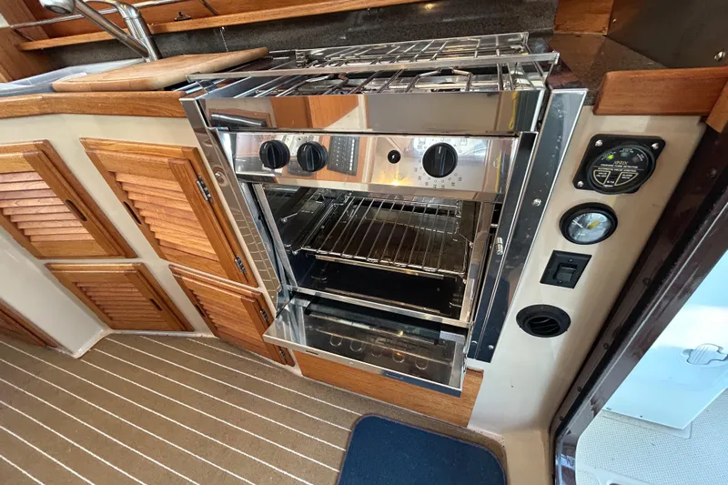  Yacht Photos Pics 2017 Ranger Tugs R-31 CB interior with stainless steel oven and wooden cabinetry.