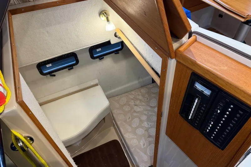  Yacht Photos Pics 2017 Ranger Tugs R-31 CB cabin interior with cozy sleeping area and control panel.