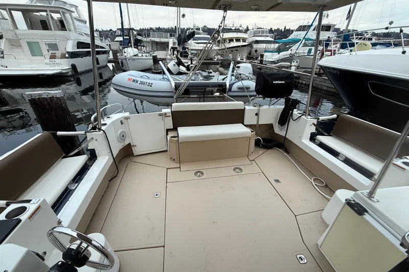  Yacht Photos Pics 2017 Ranger Tugs R-31 CB boat interior at marina, featuring spacious seating and covered deck.
