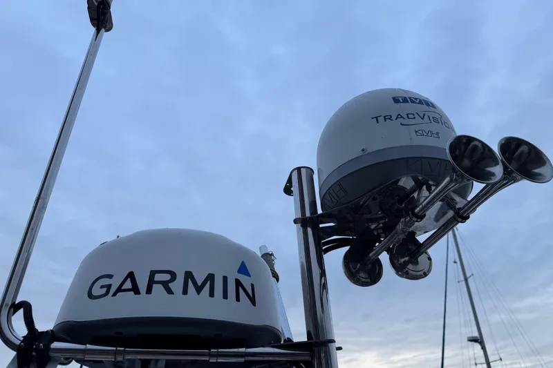  Yacht Photos Pics Garmin and TracVision equipment on 2017 Ranger Tugs R-31 CB boat against cloudy sky.