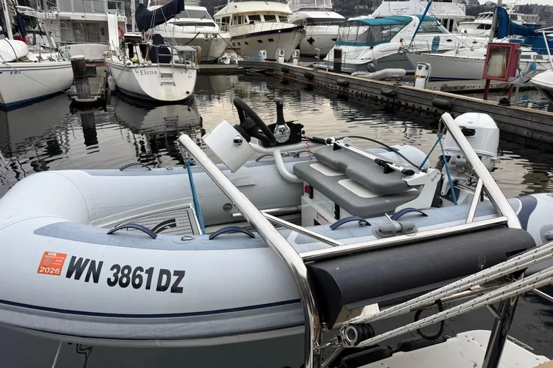  Yacht Photos Pics A 2017 Ranger Tugs R-31 CB docked among various boats in a marina.
