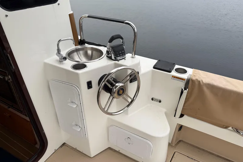  Yacht Photos Pics 2017 Ranger Tugs R-31 CB helm with sink, steering wheel, and controls by the water.