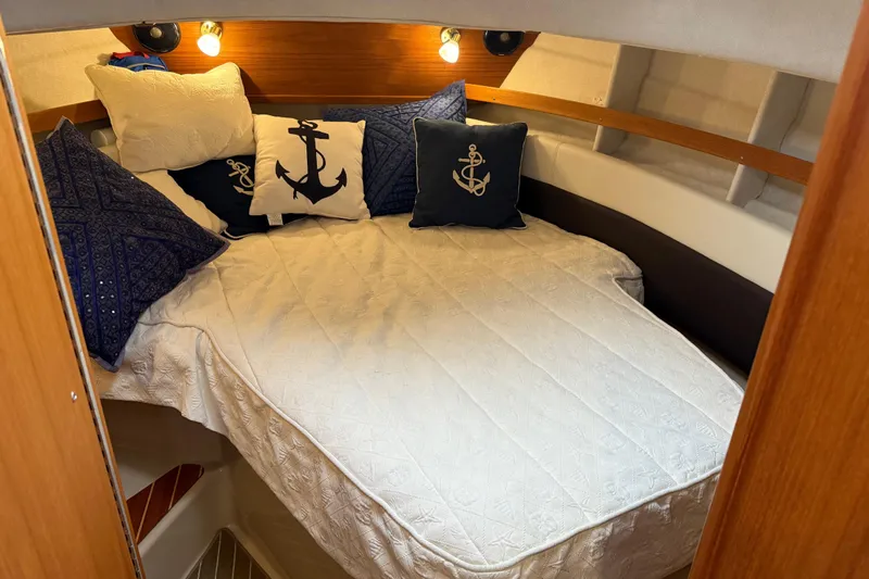  Yacht Photos Pics Cozy cabin interior of 2017 Ranger Tugs R-31 CB with nautical-themed pillows.