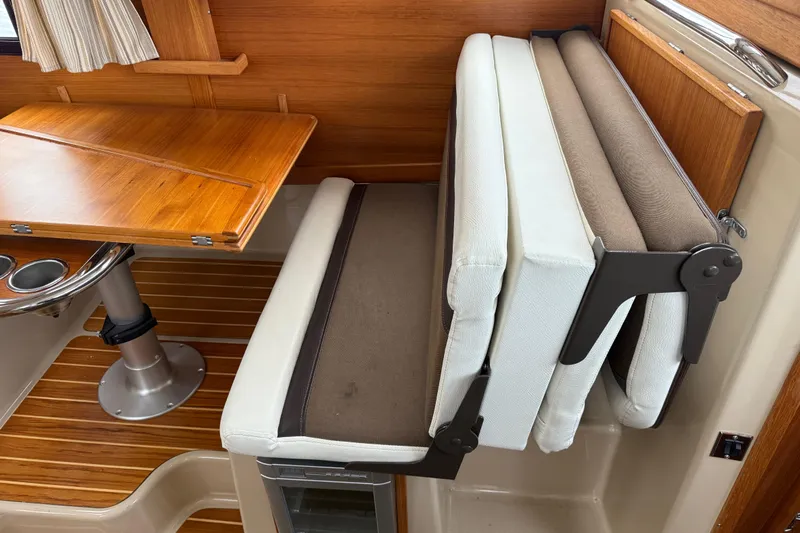  Yacht Photos Pics 2017 Ranger Tugs R-31 CB interior with foldable seating and wooden table.