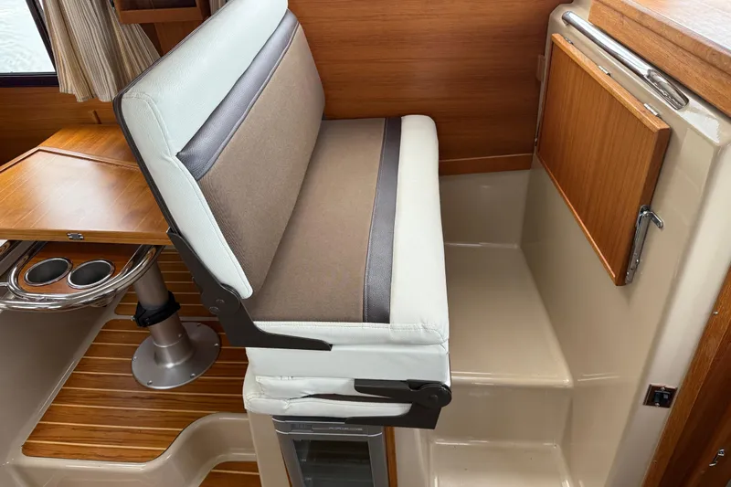 Yacht Photos Pics 2017 Ranger Tugs R-31 CB interior with cushioned seating and wooden accents.