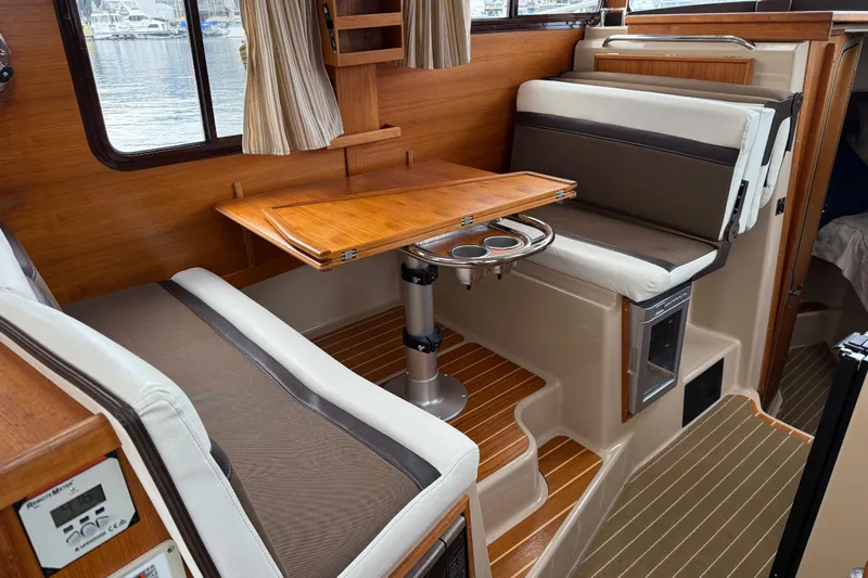  Yacht Photos Pics Interior of 2017 Ranger Tugs R-31 CB with wooden table and seating area.