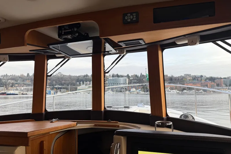  Yacht Photos Pics Interior view from 2017 Ranger Tugs R-31 CB, overlooking a scenic waterfront.