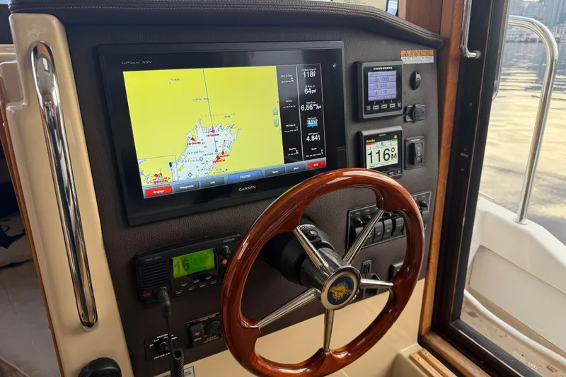  Yacht Photos Pics 2017 Ranger Tugs R-31 CB helm with navigation display and wooden steering wheel.