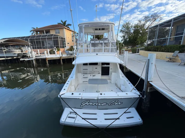  Yacht Photos Pics 2002 Riviera 40 Convertible yacht docked at marina, rear view.