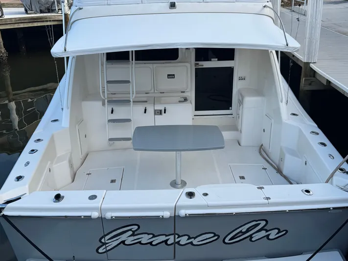  Yacht Photos Pics 2002 Riviera 40 Convertible yacht with spacious deck and table, docked at marina.