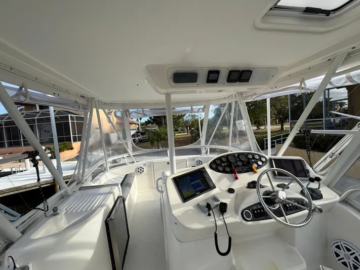  Yacht Photos Pics 2002 Riviera 40 Convertible yacht cockpit with steering wheel and navigation equipment.