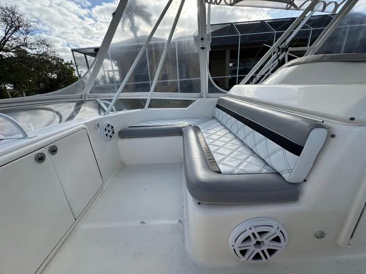  Yacht Photos Pics 2002 Riviera 40 Convertible boat interior with cushioned seating and clear canopy.
