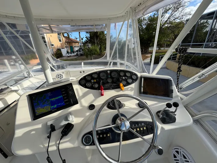  Yacht Photos Pics 2002 Riviera 40 Convertible boat cockpit with navigation screens and steering wheel.
