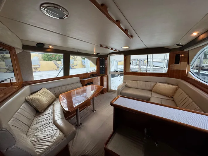  Yacht Photos Pics Luxurious interior of 2002 Riviera 40 Convertible yacht with plush seating and wooden accents.