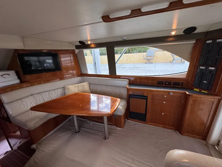  Yacht Photos Pics Interior of 2002 Riviera 40 Convertible yacht with dining area and wooden cabinetry.