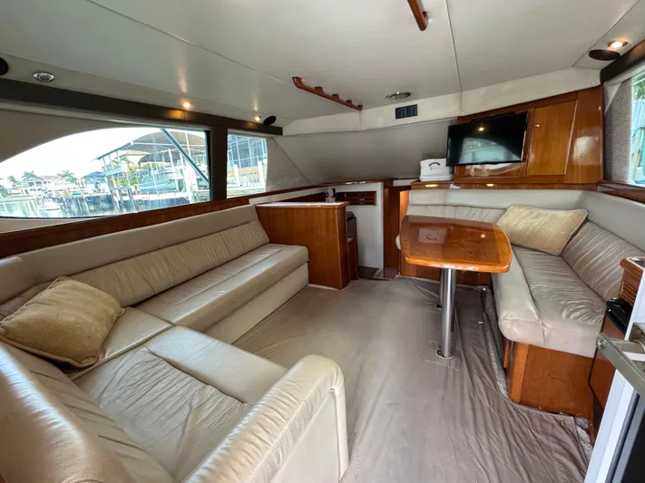  Yacht Photos Pics Luxurious interior of 2002 Riviera 40 Convertible yacht with plush seating and wooden accents.