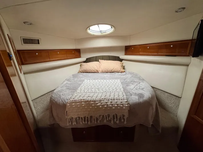  Yacht Photos Pics Cozy bedroom in 2002 Riviera 40 Convertible yacht with elegant wood accents.