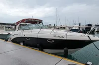 2009 Chaparral 290 Signature boat docked at marina, overcast sky.