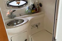 2009 Chaparral 290 Signature boat bathroom with sink, toilet, and toiletries.