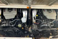 Twin engines of a 2009 Chaparral 290 Signature boat, showcasing detailed mechanical components.