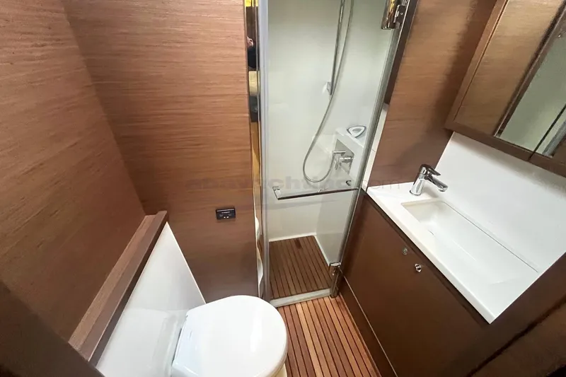  Yacht Photos Pics 2019 Lagoon 52 S yacht bathroom with wood accents, shower, and sink.