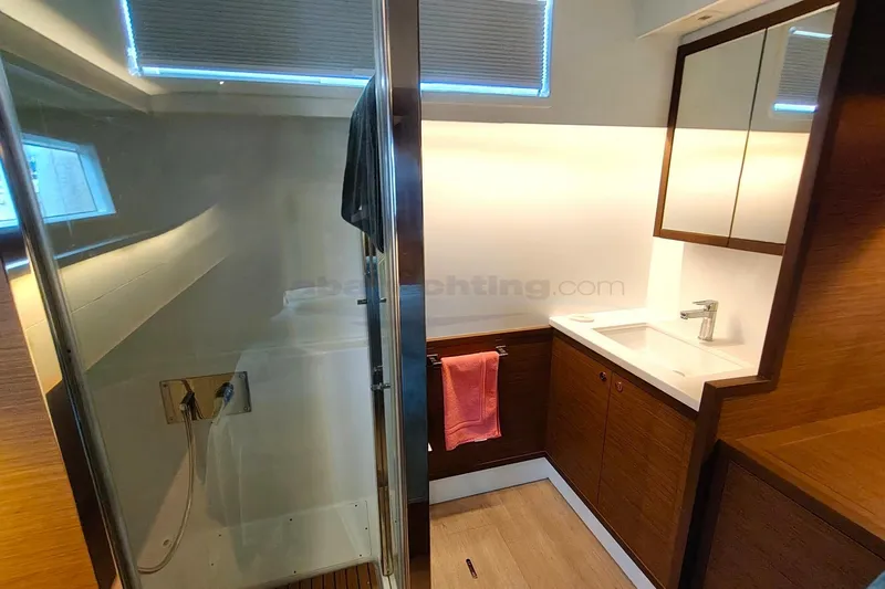  Yacht Photos Pics Luxurious bathroom in 2019 Lagoon 52 S yacht with modern fixtures and wooden accents.