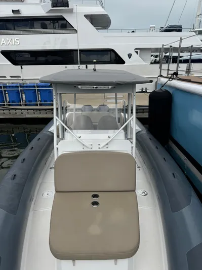  Yacht Photos Pics Modern Iguana X100 boat docked at marina, featuring sleek design and spacious seating.